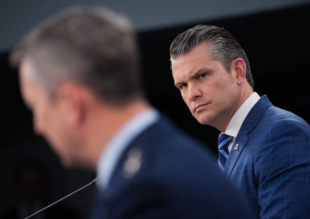 U.S. Secretary of War Pete Hegseth (R) listens as Chairman of the Joint Chiefs of Staff Gen. Dan Caine speaks during a press briefing at the Pentagon on April 08, 2026 in Arlington, Virginia.