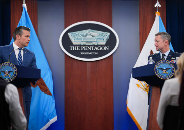 U.S. Secretary of War Pete Hegseth (L) looks to Chairman of the Joint Chiefs of Staff Gen. Dan Caine as he speaks during a press briefing at the Pentagon on April 08, 2026 in Arlington, Virginia.