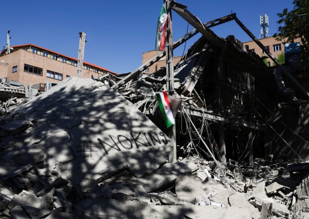 An Iranian flag hangs amidst the rubble of a building of the Sharif University of Technology, which was damaged in a strike, amid the US-Israeli conflict with Iran, in Tehran, Iran, April 7, 2026.