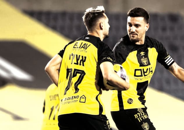 BEITAR JERUSALEM players celebrate a dramatic late winner at Teddy Stadium – their joy echoing through empty stands as fans cheer from afar in homes and shelters across Israel. 