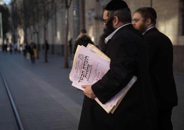 REPRESENTATIVES OF the Chief Rabbinate of Israel cross Jaffa Street in Jerusalem as they deliver a kosher certificate to a local restaurant.