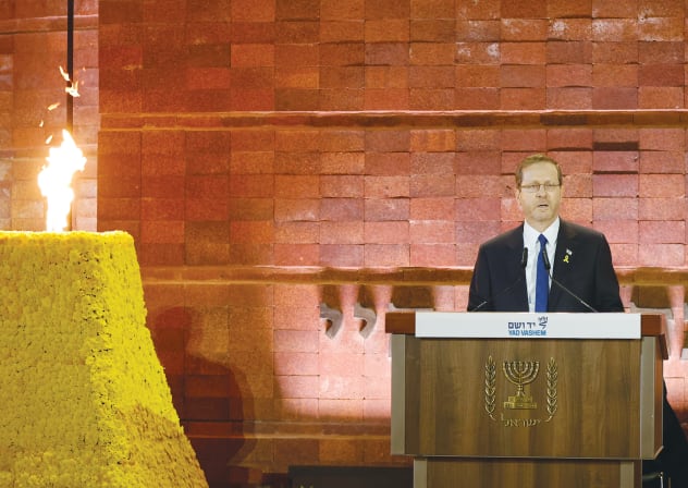 THIS YEAR’S eight survivors carry within them an enormous sweep of Jewish history: ghettos, pits, forests, camps, cattle cars, shootings, hiding places, and then, after all that, lives rebuilt in Israel. Here, President Isaac Herzog stands beside the memorial torch at Yad Vashem.