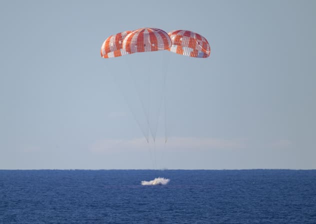 NASA's Orion spacecraft with Artemis II crewmembers NASA astronauts Reid Wiseman, commander; Victor Glover, pilot; Christina Koch, mission specialist; and CSA (Canadian Space Agency) astronaut Jeremy Hansen, mission specialist aboard is seen as it lands in the Pacific Ocean on April 10, 2026.