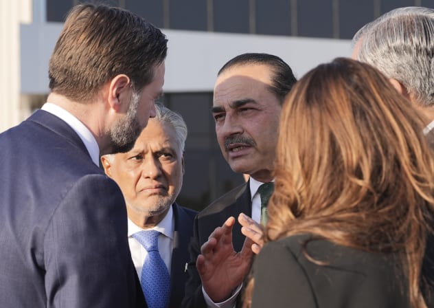 US Vice President JD Vance, left, talks to Pakistan's Chief of Defence Forces and Chief of Army Staff Field Marshall Asim Munir, right, and Pakistani Deputy Prime Minister and Foreign Minister Mohammad Ishaq Dar, center, before boarding Air Force Two after attending talks on Iran on April 12, 2026.