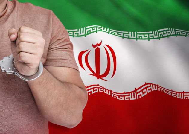 An illustration of a man in handcuffs in front of a backdrop of the Iranian flag.