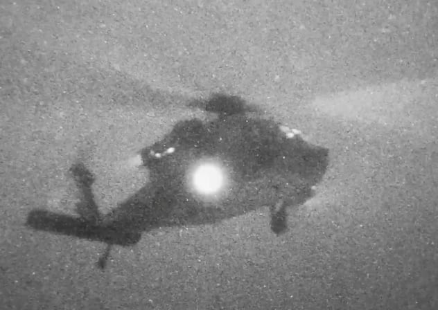A helicopter carries U.S. Marines from the amphibious assault ship USS Tripoli at an unknown location, in what the U.S. Central Command (CENTCOM) says is an operation to board and seize Iranian-flagged cargo ship M/V Touska, in this screen grab taken from a handout video released on April 20, 2026. 