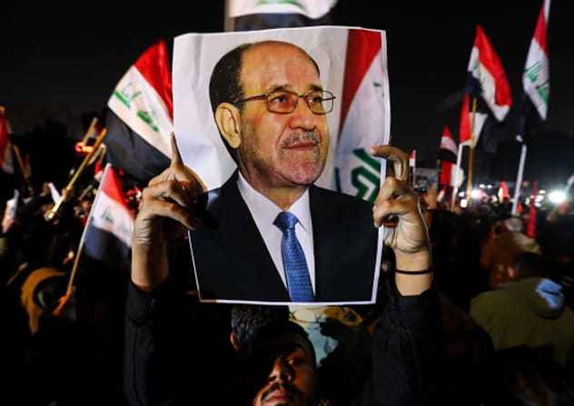  A protester holds a portrait of former Iraqi prime minister Nouri al-Maliki during a protest against US President Donald Trump near the US embassy in Baghdad, on Jan. 29, 2026.