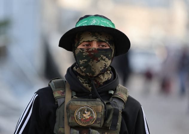 A HAMAS terrorist stands on a street during Eid al-Fitr in Gaza City.