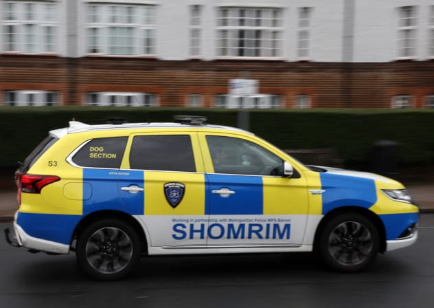 A 'Shomrim' private security car is seen driving past a synagogue in Stamford Hill, north London on October 13, 2023. 