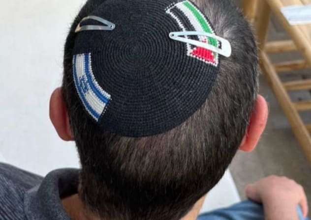 A KIPPAH with both an Israeli and Palestinian flag on it.
