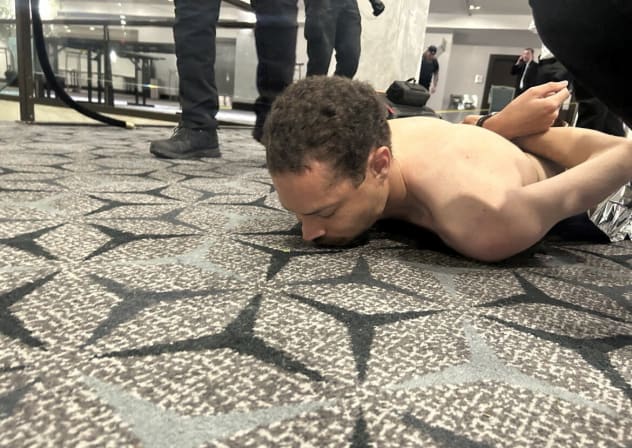 Law enforcement personnel detain Cole Tomas Allen, a suspect in the shooting incident at the White House Correspondents' Association dinner, in Washington, D.C., U.S. April 25, 2026.