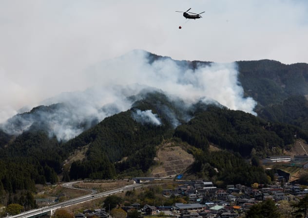  A helicopter conducts firefighting operations as wildfires continue in Otsuchi, Iwate Prefecture, Japan, April 26, 2026. 