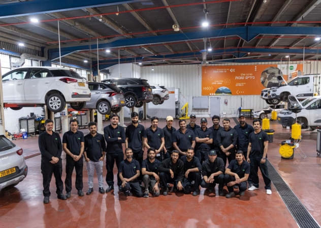 The central garage in Holon, alongside certified garage workers from India.