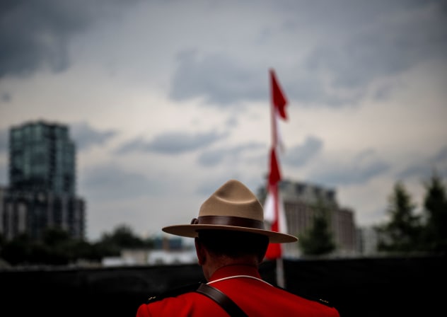 An officer of the Royal Canadian Mounted Police (RCMP) looks on during the Canada Day Celebrations in the Old Port in Montreal, Quebec, on July 1, 2025.