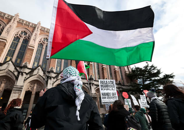 PEOPLE HOLD signs and Palestinian flags as they protest the arrest of former Columbia University student activist Mahmoud Khalil and show support for Palestinians during a "Fight for Our Rights" demonstration at the University of Washington campus in Seattle, Washington, on March 15, 2025.