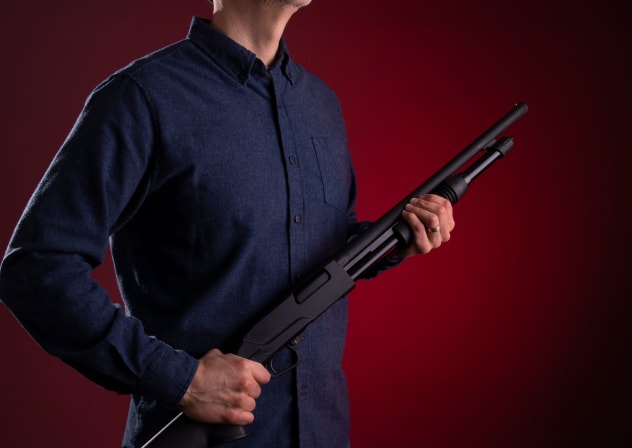 An illustrative image of a man holding a shotgun.