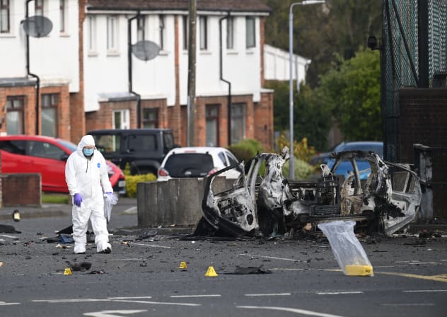  Forensic officers gather evidence at the scene of a suspected car bomb attack on Dunmurry police station on April 26, 2026 in Dunmurry, Northern Ireland. 