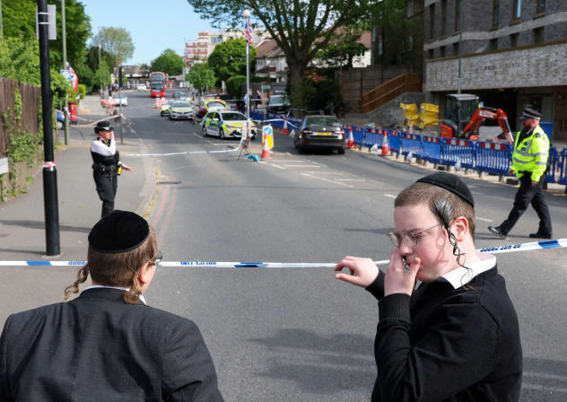Orthodox Jews stand by a police cordon, after a man was arrested following a stabbing incident in the Golders Green area, which is home to a large Jewish population, in London, Britain, April 29, 2026.