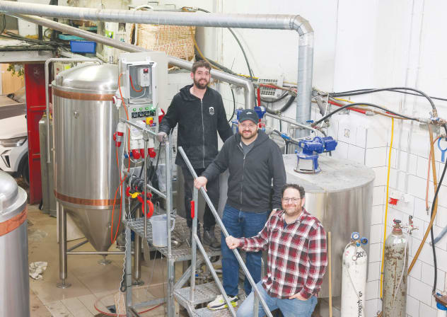 Brewmaster Mendel Shnider (top), with brother-partners Eitan and Oren Nidam in the new Jerusalem Brewing Co. in Talpiot. 