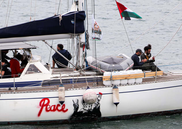 The word "peace" is painted on a boat taking part in a humanitarian flotilla as it departs for Gaza from Barcelona, Spain, April 12, 2026.