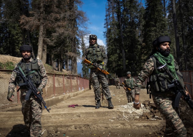 Indian security force personnel stand guard at the site of a suspected militant attack on tourists in Baisaran near Pahalgam in south Kashmir's Anantnag district, April 24, 2025.