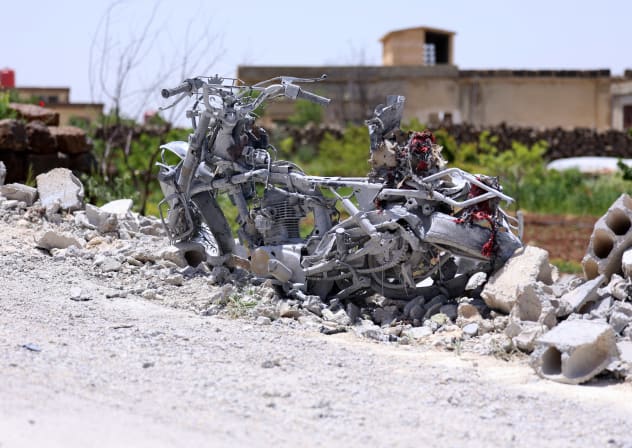 The debris of a destroyed building and a motorbike litters the ground following a Jordanian strike on reported drugs and weapons storage facilities in the village of Arman, in the southern Druze-majority province of Sweida, of which many parts are outside the control of Damascus on May 3, 2026. 