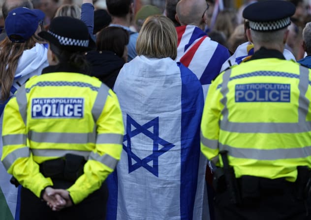 Metropolitan Police officers stand on duty as people attend a rally organised by the Campaign Against Antisemitism, opposite Downing Street in central London on April 30, 2026.
