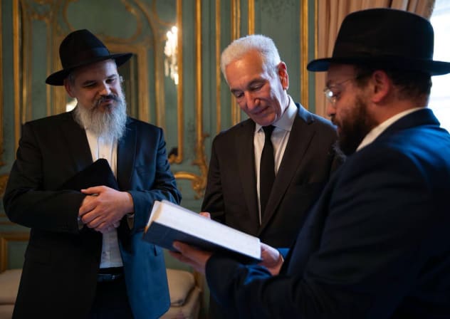 US Ambassador to France Charles Kushner stands with two members of Chabbad in his Paris residence.
