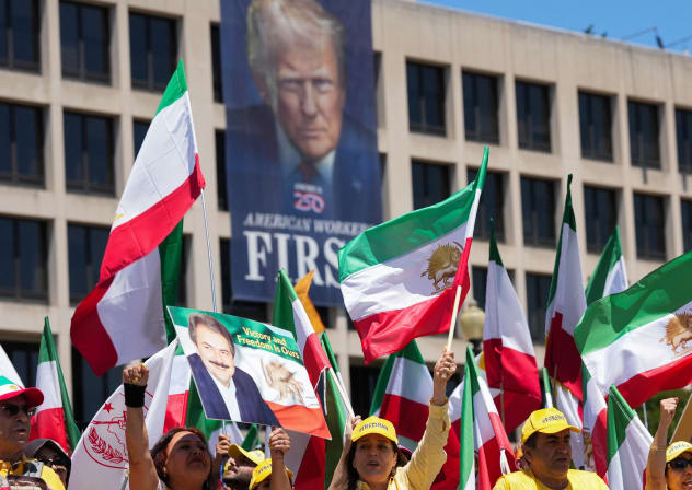 Iranian Americans and supporters of the National Council of Resistance of Iran take part in a march passing in front of the U.S Department of Labor building with a banner with the image of U.S. President Donald Trump, in Washington, DC, US, May 16, 2026.