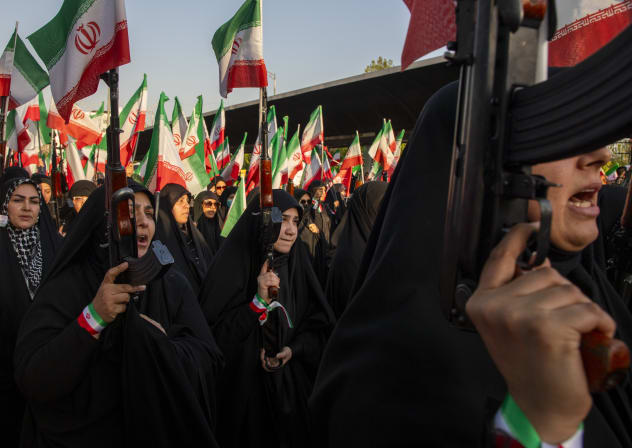 Women hold rifles and flags during a pro-government National Army Day demonstration on April 17, 2026 in Tehran, Iran; illustrative.