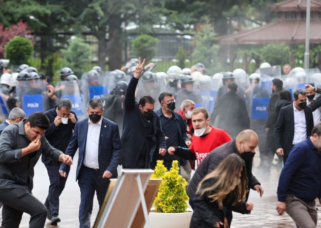 Supporters of ousted Republican People’s Party (CHP) leader Ozgur Ozel react as riot police enter the party’s headquarters to evict its leadership after authorities ordered enforcement of a court ruling removing them from the building, in Ankara, Turkey, May 24, 2026.