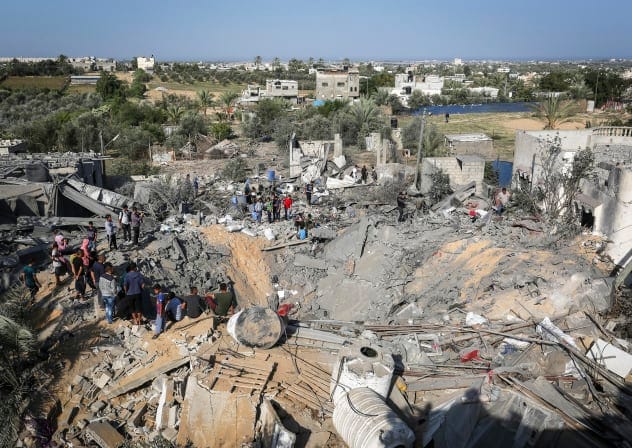 PALESTINIANS CHECK the destruction following an Israeli air strike, in Khan Yunis in the southern Gaza Strip, on November 14, 2019.