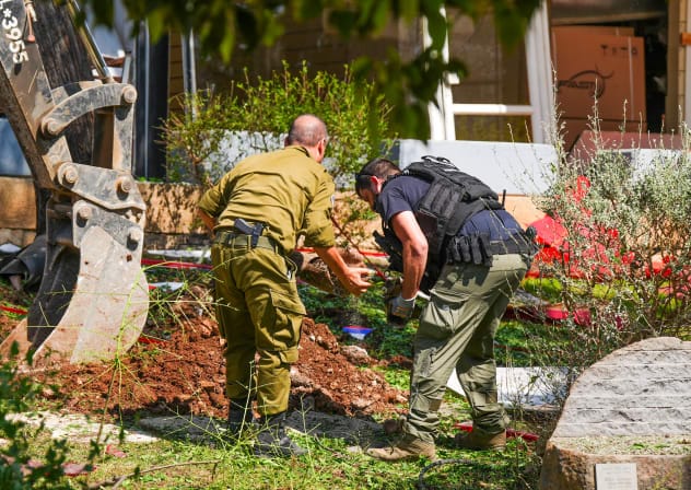 Israeli security forces and civilians at the scene where a missile fired from Lebanon toward Israel overnight caused damage in the northern Israeli city of Kiryat Shmona, May 30, 2026.