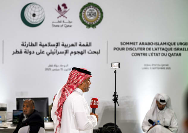 A reporter for Sky News Arabia television channel speaks before the camera from the media centre set up for the 2025 ArabIslamic extraordinary summit in Doha on September 15, 2025.