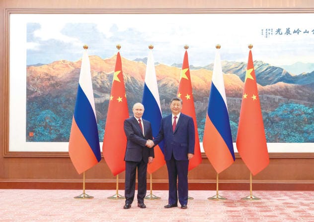 Russian President Vladimir Putin and Chinese President Xi Jinping pose at Beijing’s Great Hall of the People, May 20.