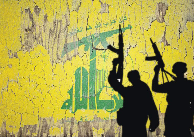 Hezbollah flag mural provides backdrop for gun-wielding shadows.