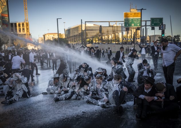 Ultra orthoodx jewish men block a road and clash with police during a protest against the jailing of yeshiva students who failed to comply with an army recruitment order, in Jerusalem, June 1, 2026.