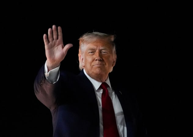 US President Donald Trump gestures as he boards Air Force One, after attending Game 3 of the NBA Finals, at John F. Kennedy International Airport in New York, June 8, 2026.