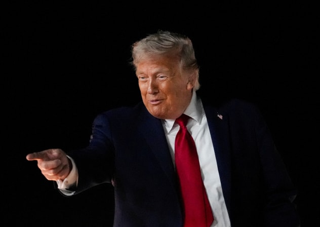 US President Donald Trump reacts as he boards Air Force One, after attending Game 3 of the NBA Finals, at John F. Kennedy International Airport in New York.