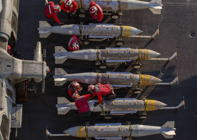 US Sailors prepare to stage ordnance on the flight deck of Nimitz-class aircraft carrier USS Abraham Lincoln (CVN 72) in support of Operation Epic Fury on February 28, 2026 at Sea.