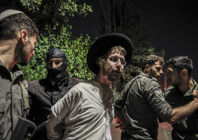 Ultra-Orthodox Jewish men protest outside the home of Military Police commander Brig.-Gen. Yuval Yamin, in Ashkelon, April 28, 2026