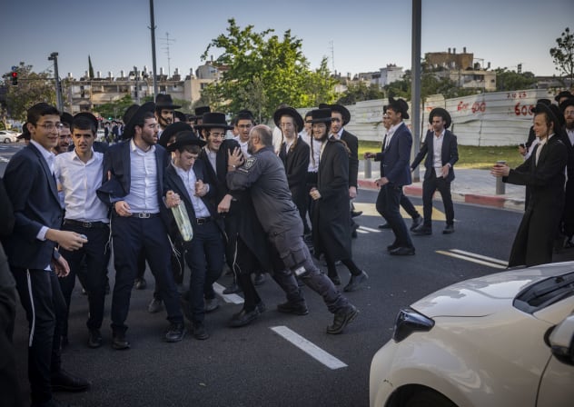 Ultra-Orthodox Jewish protesters demonstrate against the arrest of ultra orthodox jewish men who took part in a protest outside the home of Supreme Court Justice Noam Sohlberg and were later handed over to the military police, outside the Abu Kabir detention facility in Tel Aviv, June 10, 2026. 