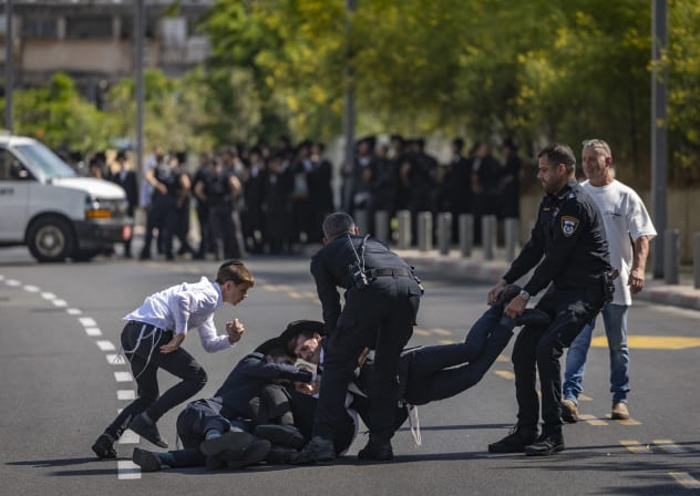 Ultra-Orthodox Jewish protesters demonstrate against the arrest of ultra orthodox jewish men who took part in a protest outside the home of Supreme Court Justice Noam Sohlberg and were later handed over to the military police, outside the Abu Kabir detention facility in Tel Aviv, June 10, 2026.