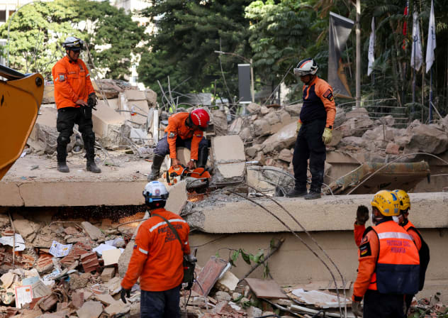 Emergency services work at the site of a collapsed building after earthquakes hit the country, in Caracas, Venezuela, June 25, 2026. 