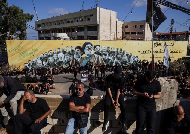 Shi'ite mourners gather near a banner depicting late former Hezbollah leader Hassan Nasrallah and and other senior figures as they mark Ashura, the holiest day on the Shi'ite Muslim calendar, in the southern suburbs of Beirut, Lebanon, June 26, 2026. 