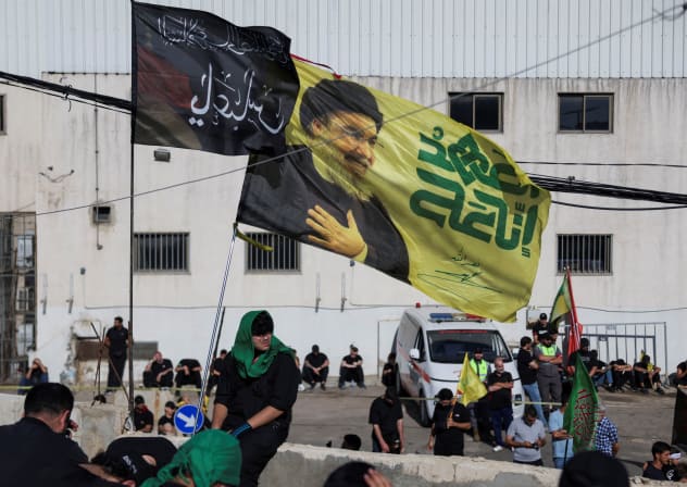 A flag depicting late former Hezbollah leader Hassan Nasrallah flutters as Shi'ite mourners mark Ashura, in the southern suburbs of Beirut, Lebanon, June 26, 2026