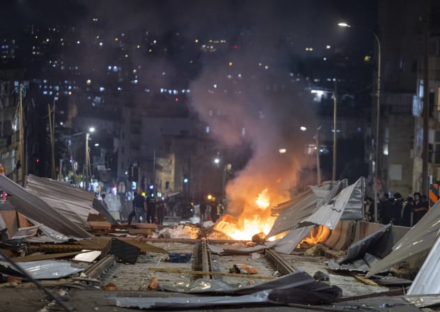 Ultra-Orthodox Jewish protesters set fire to construction materials during a protest against construction work on the Jerusalem Light Rail in the Bar-Ilan area of Jerusalem, June 8, 2026. 