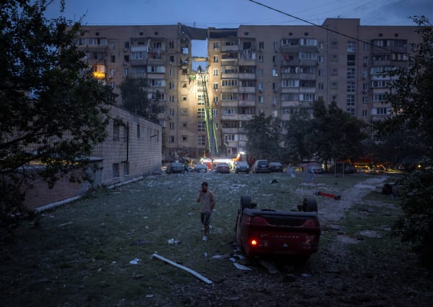 A flipped-over car lies near an apartment building, which was heavily damaged during Russian missile and drone strikes, amid Russia's attack on Ukraine, in Kyiv, Ukraine July 6, 2026.