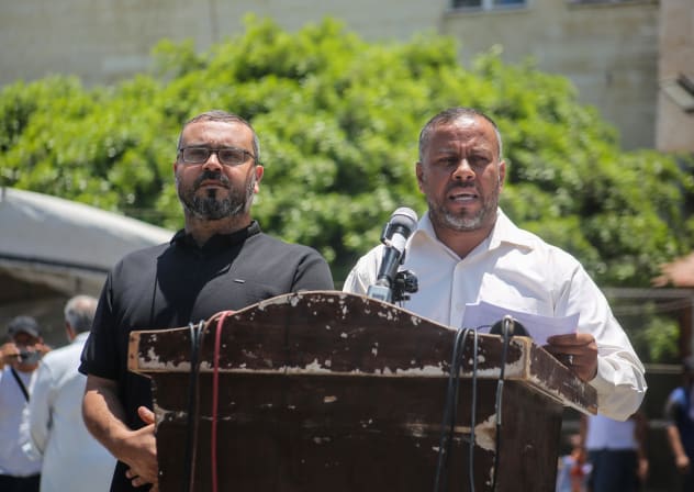 Government Media Office Director Ismail Thawabteh (R) and Hamas spokesperson Hazem Qassem (L) speak at a press conference regarding the resignation of the head of the Government Emergency Committee and the acting head of Government Follow-up.