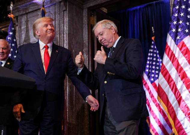 US Senator Lindsey Graham (R-SC) gestures, while standing next to former US President Donald Trump, during Donald Trump's campaign stop to unveil his leadership team, at the South Carolina State House in Columbia, South Carolina, US, January 28, 2023.